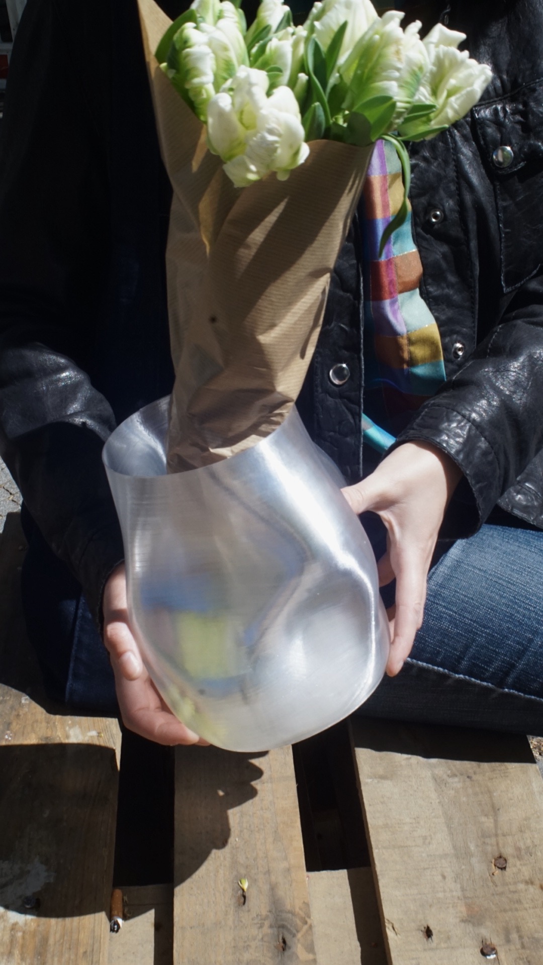 Glass vase with tulips outdoors